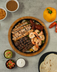 grilled chicken, beef and shrimp with vegetables