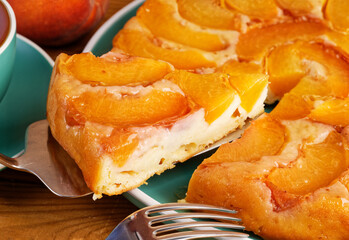 Closeup homemade pie with peaches on wooden table. Shallow focus.