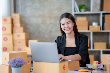 Online business owner Asian woman are using computer to check orders and customer addresses so that they can be delivered to their customers correctly.