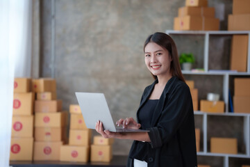 Online business owner Asian woman are using computer to check orders and customer addresses so that they can be delivered to their customers correctly.