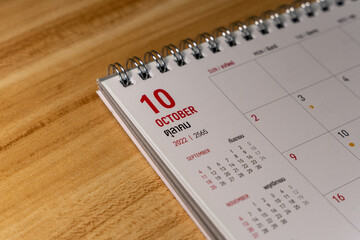 Oct month 2022 Calendar page on wooden background