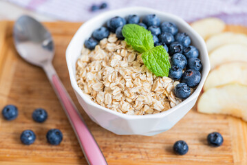 delicious oatmeal porridge with blueberry and apple for breakfast