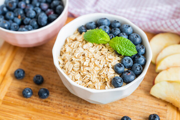 delicious oatmeal porridge with blueberry and apple for breakfast