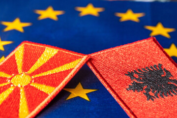 The flags of North Macedonia and Albania against the background of the Symbol of the European...