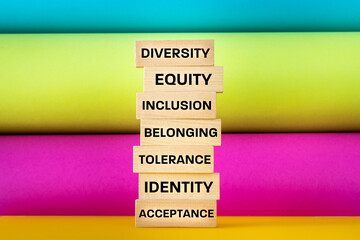 words written on a wooden block, Diversity equity inclusion belonging to tolerance identity, acceptance, Concept colorful background, Teamwork, creative use of diversity