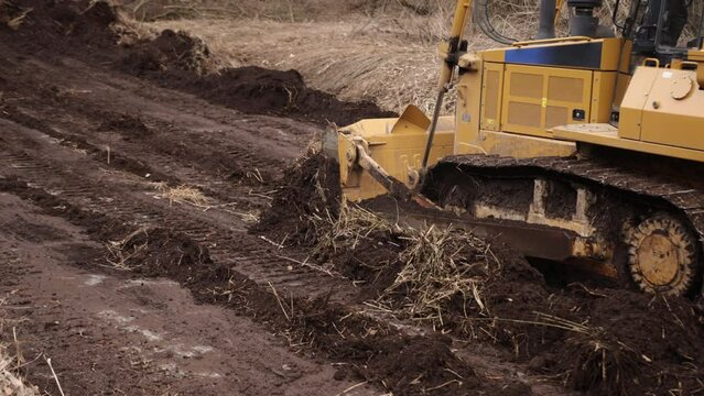 Heavy backhoe construction machinery equipment concept. Earth mover, bulldozer. Big yellow front-end loader or all-wheel bulldozer. Heavy machinery machine manufacturing equipment for open-pit mining.