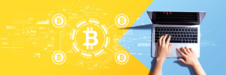 Obraz na płótnie Canvas Bitcoin theme with person using a laptop computer