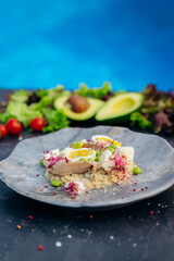 Oatmeal with boiled egg, bacon and green peas. Healthy and tasty breakfast