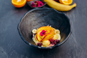 Sweet oatmeal with fried cheese balls, peach and cranberries. Healthy breakfast