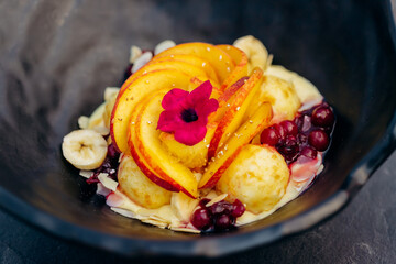 Sweet oatmeal with fried cheese balls, peach and cranberries. Healthy breakfast