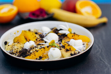 Sweet pancakes with ice cream, chocolate and orange served on white plate. Healthy and tasty breakfast