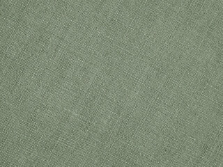 Light green woven surface close up. Linen textile texture. Fabric sewing background. Textured braided backdrop. Len green-gray wallpaper. Macro