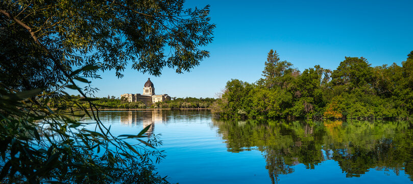 Tranquil Wascana Lake and Forest Park landscape in Regina, Saskatchewan, Canada, with the view of the Saskatchewan Legislative Building.