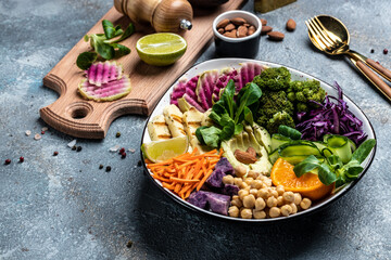 Healthy vegetarian buddha bowl salad with halloumi cheese, avocado, cucumber, chickpeas, watermelon...