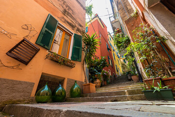 italian street with staircase and colorful houses