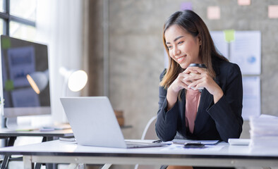 Business Accountant Young Asian female working on a laptop, doing calculator planning analyzing the financial report, business plan investment, finance analysis concept	