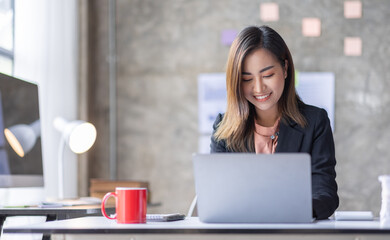 Fototapeta premium Business Accountant Young Asian female working on a laptop, doing calculator planning analyzing the financial report, business plan investment, finance analysis concept 