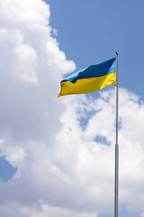 Ukraine flag large national symbol waving on the blue sky with clipping path. Large yellow blue Ukrainian state flag, Independence Constitution, National holiday. Democracy and politics. Symbol of win