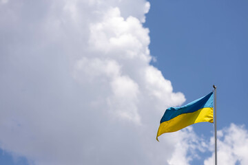 Ukraine flag large national symbol waving on the blue sky with clipping path. Large yellow blue Ukrainian state flag, Independence Constitution, National holiday. Democracy and politics. Symbol of win