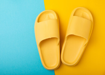 Stylish rubber slippers on a blue background.Replacement shoes.Beach shoes.Copy space. Place for text.
