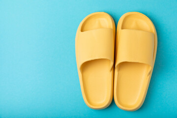 Stylish rubber slippers on wooden background.Changeable shoes.Beach shoes.Copy space. Place for text.