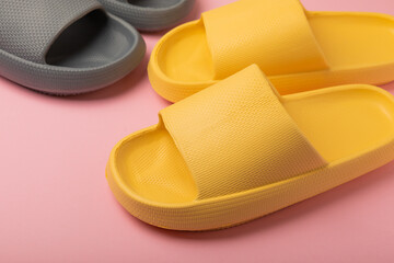 Stylish rubber slippers on a pink background.Changeable shoes.Beach shoes.Copy space. Place for text.