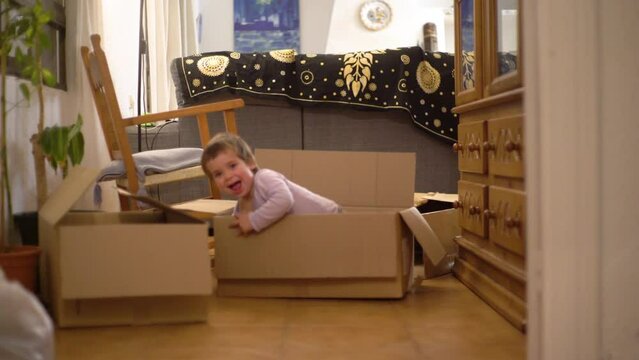 Little kids playing with moving boxes - sibling kids having fun - children playing, having fun
