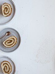 Pieces of biscuit roll with apple jam on a plates. White background, flat lay. Copy space
