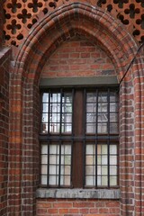 Window in the wall of the Gothic town hall in Toruń, Poland.