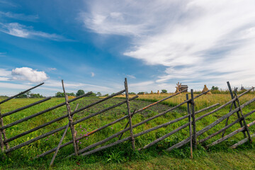 Wooden fence of the farm, made in the peoples of the Russian tradition of the north