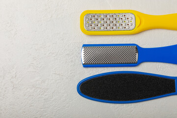 Foot file and grater on white marble background. Foot skin care product. Pumice stone file to remove dead skin from feet. Care and beauty concept. Copy space.