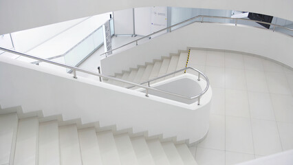 Empty modern office building interior. Media. Minimalistic design with beautiful white stairs and...
