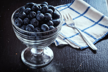 fresh ripe blueberries in glass bowl. Healthy eating and nutrition concept.