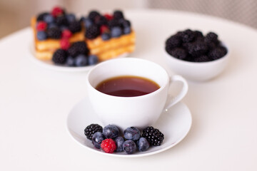 
Morning breakfast with cup of tea, waffles and berries