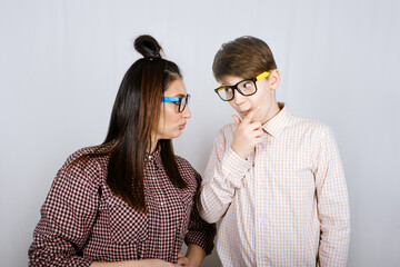 Studio Portrait of happy family mom and teenager son boy in colored glasses having fun