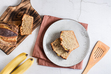Pieces of banana bread on a plate on the table. Homemade breakfast. Top view