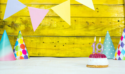 Colorful card happy birthday with festive decorations with cake and burning candles. Copy space....