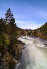 Naklejka na ściany i meble The Stuguflåt Bridge (Norwegian: Stuguflåtbrua or Stuguflåten bru), a stone railway bridge on the Rauma Line over the Rauma River in Innlandet county, Norway.