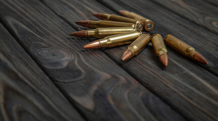 Rifle cartridges on a dark wooden back