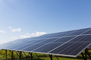  Solar panels on the background of a blue cloudy sky. Solar power plant. Blue solar panels. An alternative source of electricity. Solar farm in the field.