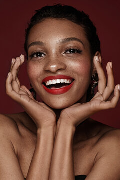 Beautiful black woman with a smile and red lips and freckles. Beauty face.