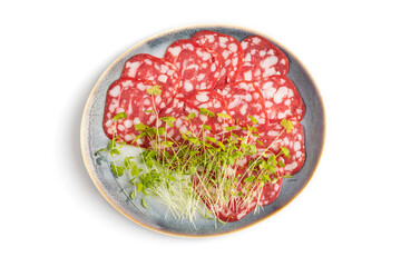 Slices of smoked cervelat salami sausage with spinach microgreen isolated on white, top view, close up.
