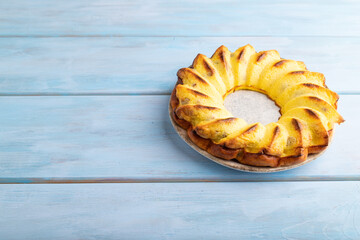 Cheesecake on blue, top view, copy space.