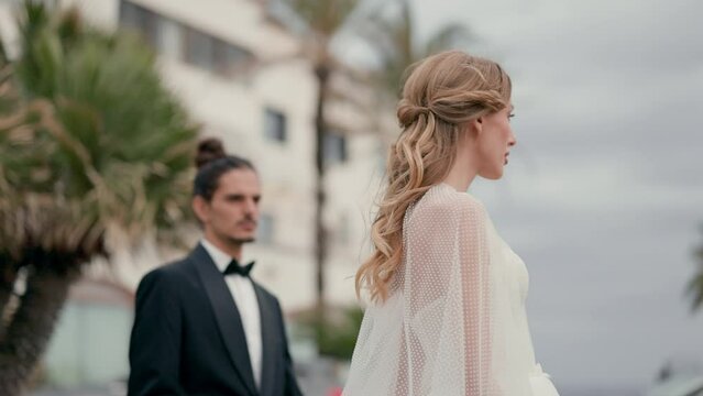 Beautiful Bride And Groom Outdoors. Pretty Girl In White Dress And Guy In Suit.