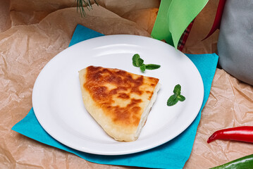 a slice of cheese pie. a traditional Georgian khachapuri cheese pie. a portion for one served on a plate.