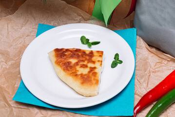 a slice of cheese pie. a traditional Georgian khachapuri cheese pie. a portion for one served on a plate.