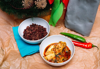 two servings of Georgian dishes. a deep plate of chakhohbili - a traditional Georgian dish of chicken with herbs. a deep plate of lobio - a dish of red beans.