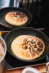 whole cheese pie. not sliced. traditional Georgian khachapuri cheese pie. pan fried pie.