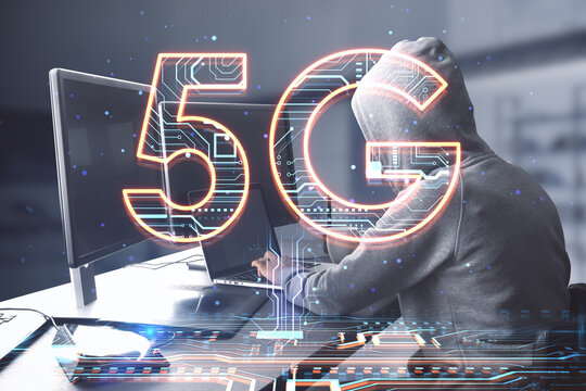 Side view of hacker hands using computers at desktop with creative 5G hologram on blurry office interior background. Speed, internet, hacking, and technology, communication concept. Double exposure.