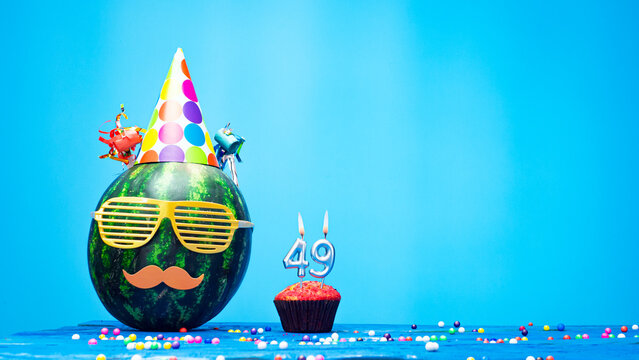 Creative happy birthday greeting with muffin festive garlands decoration. Fan greeting card. Copy space. Beautiful happy birthday background with burning candles with number 49